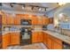 Well-lit kitchen featuring wood cabinets, modern appliances, and a convenient sink area at 494 Black Feather Loop # 117, Castle Rock, CO 80104