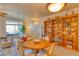 Open concept living area with dining table, bookcases, and stairs in the background at 494 Black Feather Loop # 117, Castle Rock, CO 80104