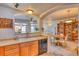 Open-concept layout with arched entryways connecting the kitchen, dining area, and living room with a large bookcase at 494 Black Feather Loop # 117, Castle Rock, CO 80104