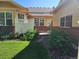Backyard showcasing a brick-accented patio with lush greenery, offering a private outdoor retreat at 221 Homestead Pkwy, Longmont, CO 80504