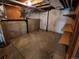 Unfinished basement area showing concrete walls and flooring with installed storage shelves at 221 Homestead Pkwy, Longmont, CO 80504