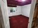 Basement featuring insulation and window, with red carpet at 221 Homestead Pkwy, Longmont, CO 80504