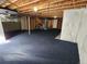 Partially finished basement with carpet, exposed ceiling, and unfinished walls at 221 Homestead Pkwy, Longmont, CO 80504