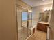Bathroom featuring a bathtub and shower combination with a glass sliding door at 221 Homestead Pkwy, Longmont, CO 80504
