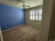 Bedroom featuring a blue accent wall, neutral carpeting, and a ceiling fan at 221 Homestead Pkwy, Longmont, CO 80504