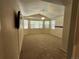 Large primary bedroom featuring plush carpeting, neutral colors, and bright natural light at 221 Homestead Pkwy, Longmont, CO 80504