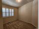 Carpeted bedroom featuring a large window providing ample natural light at 221 Homestead Pkwy, Longmont, CO 80504