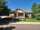 Charming single-Gathering home with a well-manicured lawn, covered front porch, and mature trees at 221 Homestead Pkwy, Longmont, CO 80504