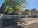 Charming home with a well-maintained front yard, decorative white picket fence, and beautiful shade tree at 221 Homestead Pkwy, Longmont, CO 80504