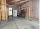 Open garage space features a refrigerator, shelving, and work table for storage or DIY projects at 221 Homestead Pkwy, Longmont, CO 80504