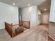 Spacious upstairs hallway featuring stairs, carpeted floors, and natural lighting from the entry door at 221 Homestead Pkwy, Longmont, CO 80504