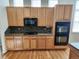 Well-equipped kitchen with oak cabinets, modern appliances, and stylish backsplash detail at 221 Homestead Pkwy, Longmont, CO 80504