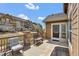 Outdoor patio area with seating, a grill, and pleasant views of neighboring homes and blue skies at 4822 Pathfinder Ct, Castle Rock, CO 80108