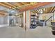 An unfinished basement with concrete floor and cinder block wall with some storage and mechanical equipment at 4822 Pathfinder Ct, Castle Rock, CO 80108