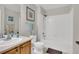 Neat bathroom featuring a sink, toilet, bathtub with shower, and beach themed decorations at 4822 Pathfinder Ct, Castle Rock, CO 80108