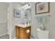 Well-lit bathroom with framed crab art and seafoam-colored towels at 4822 Pathfinder Ct, Castle Rock, CO 80108