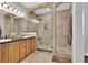 Bathroom featuring double sinks, stylish vanities, and tiled walk-in shower at 4822 Pathfinder Ct, Castle Rock, CO 80108