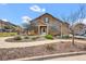 Inviting two-story home with meticulously maintained landscaping, complemented by a sunny sky at 4822 Pathfinder Ct, Castle Rock, CO 80108