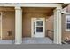 Inviting front porch with beige siding, white pillars, and the house number prominently displayed at 4822 Pathfinder Ct, Castle Rock, CO 80108