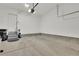An empty single car garage with an electric door and a door to the house with short stairs at 4822 Pathfinder Ct, Castle Rock, CO 80108