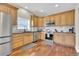 Spacious kitchen boasts stainless steel appliances, stylish countertops, hardwood floors, and ample cabinet space at 4822 Pathfinder Ct, Castle Rock, CO 80108