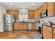 Modern kitchen features stainless steel appliances, granite countertops, hardwood floors, and custom cabinetry at 4822 Pathfinder Ct, Castle Rock, CO 80108