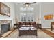 Bright living room featuring a fireplace, hardwood floors, large windows with shutters and vaulted ceiling at 4822 Pathfinder Ct, Castle Rock, CO 80108
