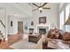 Open living room showcasing hardwood floors, fireplace, and a view of the entrance at 4822 Pathfinder Ct, Castle Rock, CO 80108