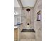 Tiled walk-in shower with a built-in bench and wall niche for bath products, showcasing luxury at 4822 Pathfinder Ct, Castle Rock, CO 80108