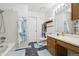 Neat bathroom featuring a tub and shower, vanity with mirror, and a tiled floor, combining functionality with style at 5895 S Killarney Way, Centennial, CO 80015