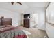 Bedroom with carpeted floors, dresser, tv, access to the bathroom, and a cozy rug enhancing comfort and style at 5895 S Killarney Way, Centennial, CO 80015