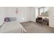 Bright bedroom features carpeted floors, a cozy bed, a study desk, and a large window, offering a versatile space at 5895 S Killarney Way, Centennial, CO 80015