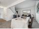 Bright dining area featuring carpeted floors, a window, a staircase, and seating for six, creating an inviting atmosphere at 5895 S Killarney Way, Centennial, CO 80015