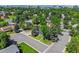 An aerial view of a home nestled in a lush, tree-filled neighborhood with city views at 5081 S Emporia St, Greenwood Village, CO 80111