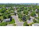 An aerial view of a neighborhood, showing its layout and green spaces in relation to the city skyline at 5081 S Emporia St, Greenwood Village, CO 80111
