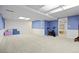 Finished basement with neutral carpet, blue walls and ample lighting at 5081 S Emporia St, Greenwood Village, CO 80111