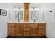 Bathroom featuring dual vanity, wood cabinets, and modern fixtures at 5081 S Emporia St, Greenwood Village, CO 80111