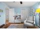 Bedroom featuring a glider chair, hardwood floors, a ceiling fan and natural light at 5081 S Emporia St, Greenwood Village, CO 80111