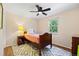 Bedroom with a wood bed frame, hardwood floors and a bright sunny window at 5081 S Emporia St, Greenwood Village, CO 80111
