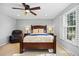 Bedroom with a ceiling fan, hardwood furniture, and a bright sunny window at 5081 S Emporia St, Greenwood Village, CO 80111