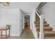 Inviting entryway with tiled floors, staircase with metal spindles, and view to living room at 5081 S Emporia St, Greenwood Village, CO 80111