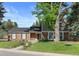 Two-story brick and siding home featuring a mature tree with a tree swing, and a lush green lawn at 5081 S Emporia St, Greenwood Village, CO 80111