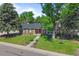 Two-story home with lush lawn, mature trees, charming front door and a tree swing at 5081 S Emporia St, Greenwood Village, CO 80111