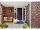 Charming front porch featuring a bench, potted plants, and brick facade at 5081 S Emporia St, Greenwood Village, CO 80111