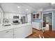 A spacious kitchen featuring white cabinets, stainless steel appliances, and access to the living area at 5081 S Emporia St, Greenwood Village, CO 80111