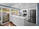 Bright kitchen features an island, stainless steel appliances, and a sliding door to the patio at 5081 S Emporia St, Greenwood Village, CO 80111