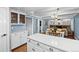 Open-concept kitchen with quartz counters overlooks the dining and living areas, promoting connectivity and style at 5081 S Emporia St, Greenwood Village, CO 80111