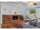 Charming living room features a brick fireplace flanked by built-in bookshelves and a large picture window at 5081 S Emporia St, Greenwood Village, CO 80111