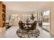 Bright dining area features a modern table set, ample natural light, and stylish decor for cozy gatherings at 6585 E Nevada Pl, Denver, CO 80224