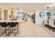 Modern kitchen with stainless steel appliances, white cabinetry, and a spacious island with seating, great for cooking at 6585 E Nevada Pl, Denver, CO 80224